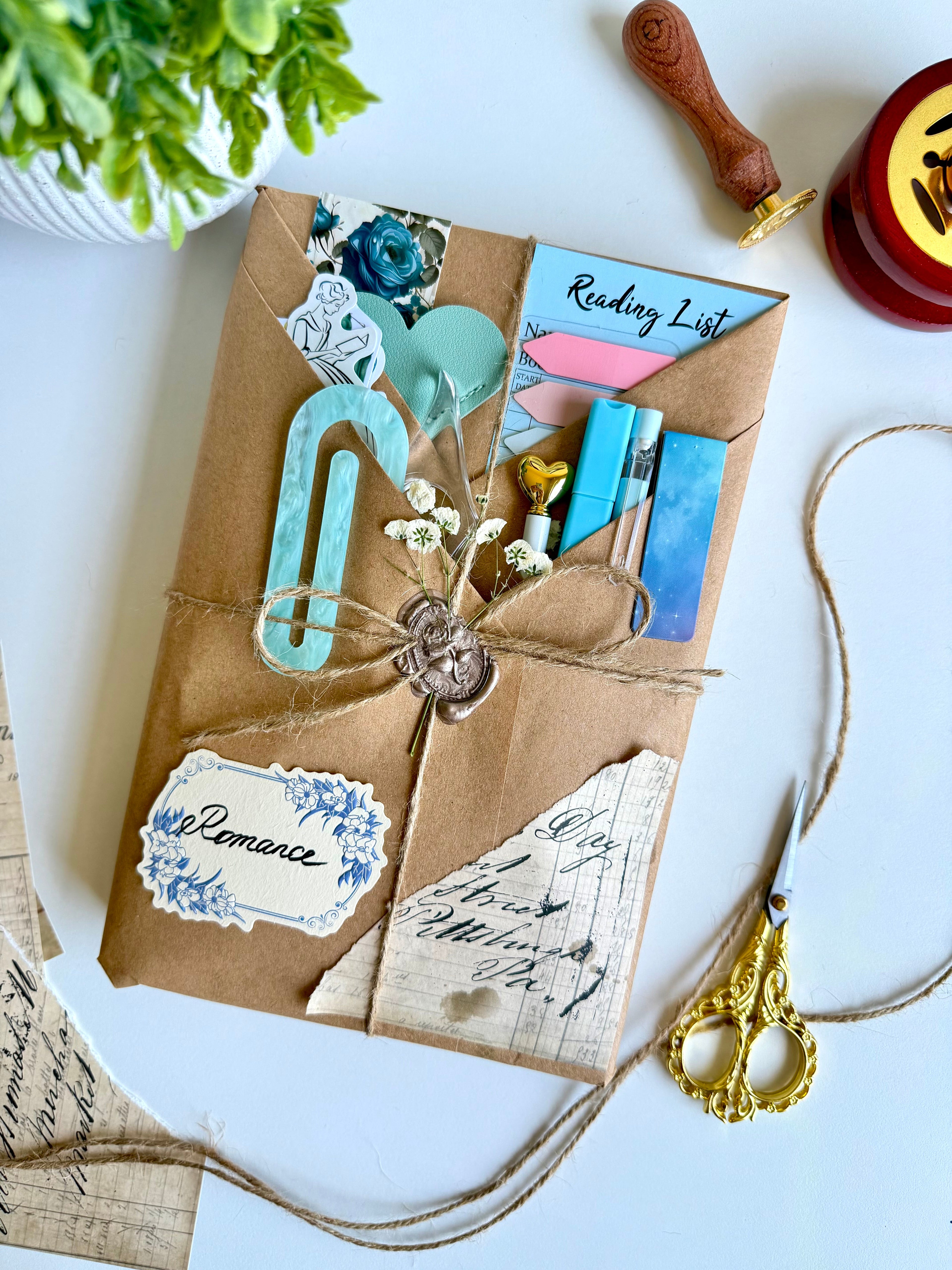 Decorative package with stationery items on a white surface