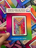 Colorful printed iron-on patch held by a hand with a multicolored background.