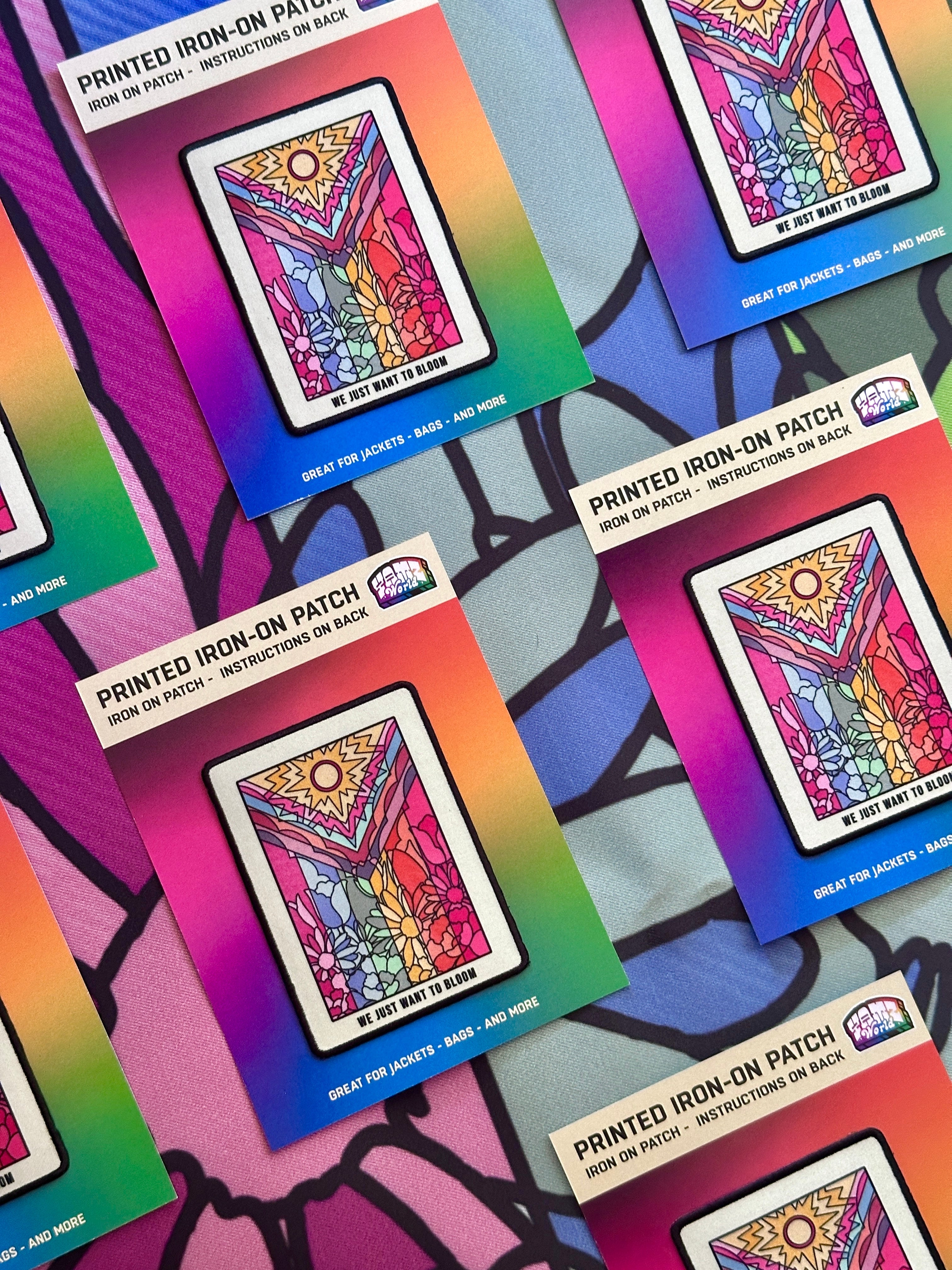 Colorful iron-on patches in packaging on a multicolored background