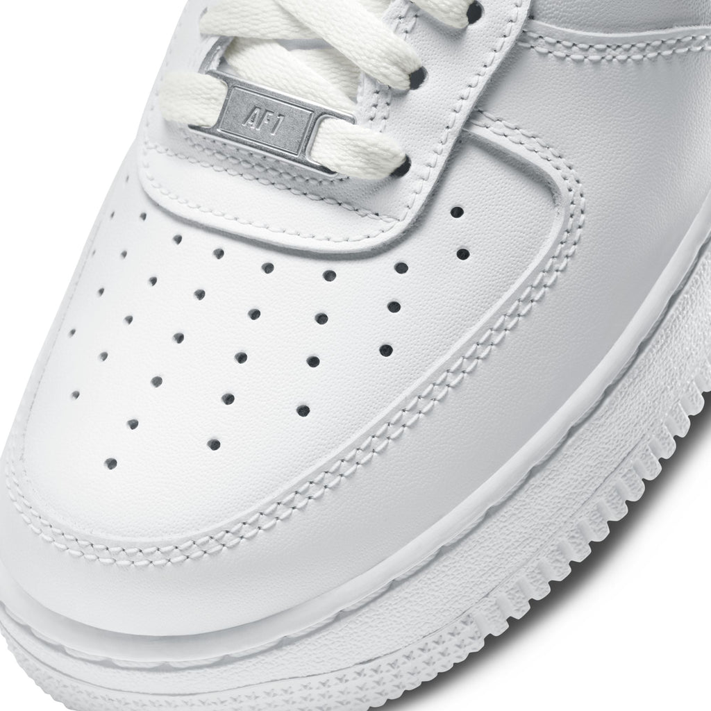 Close-up of a white sneaker with visible brand logo on a white background
