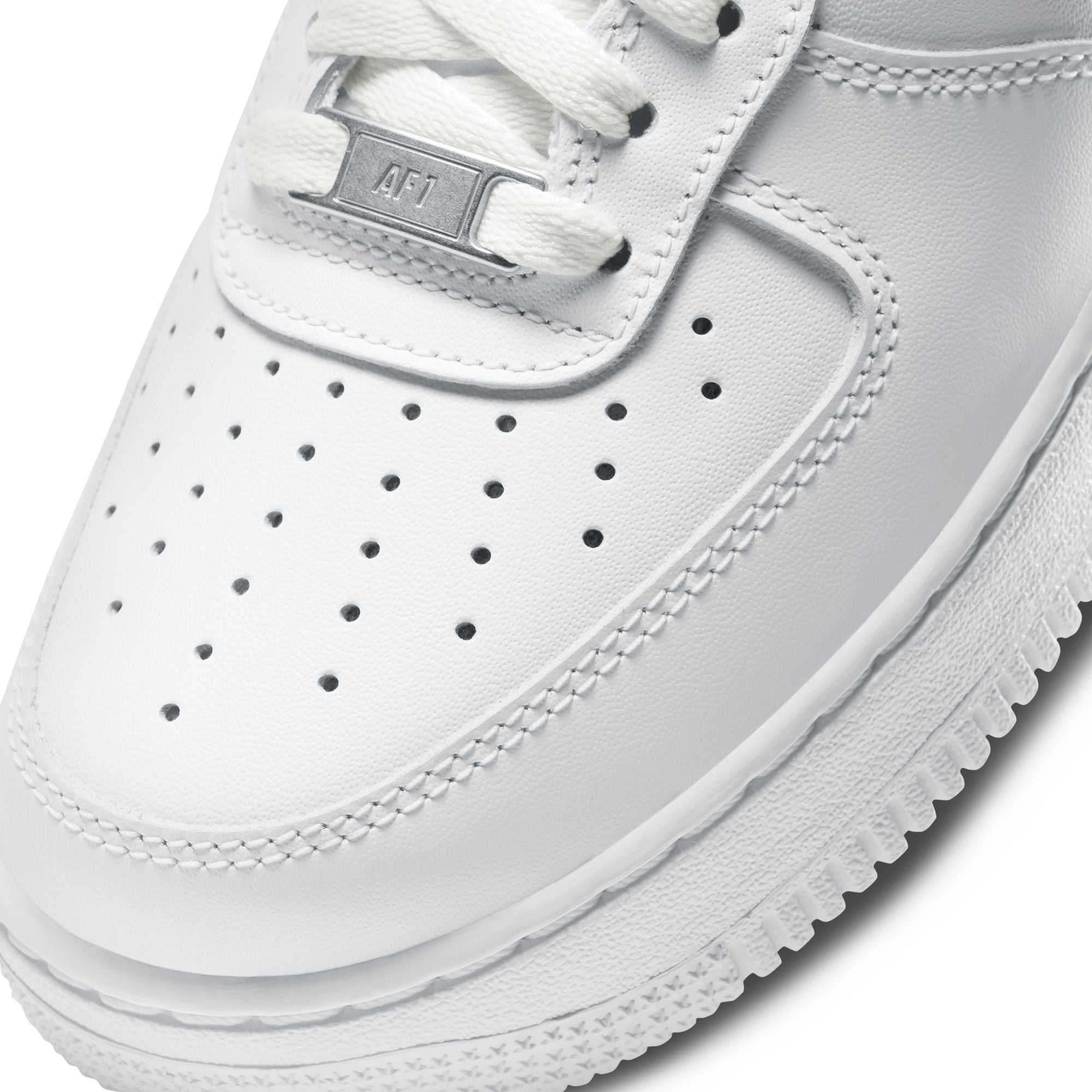 Close-up of a white sneaker with visible brand logo on a white background