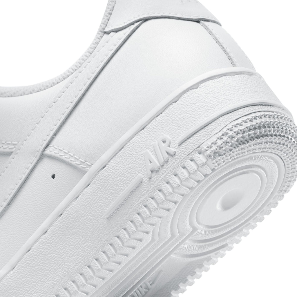 Close-up of a white sneaker with 'Nike' branding on a white background