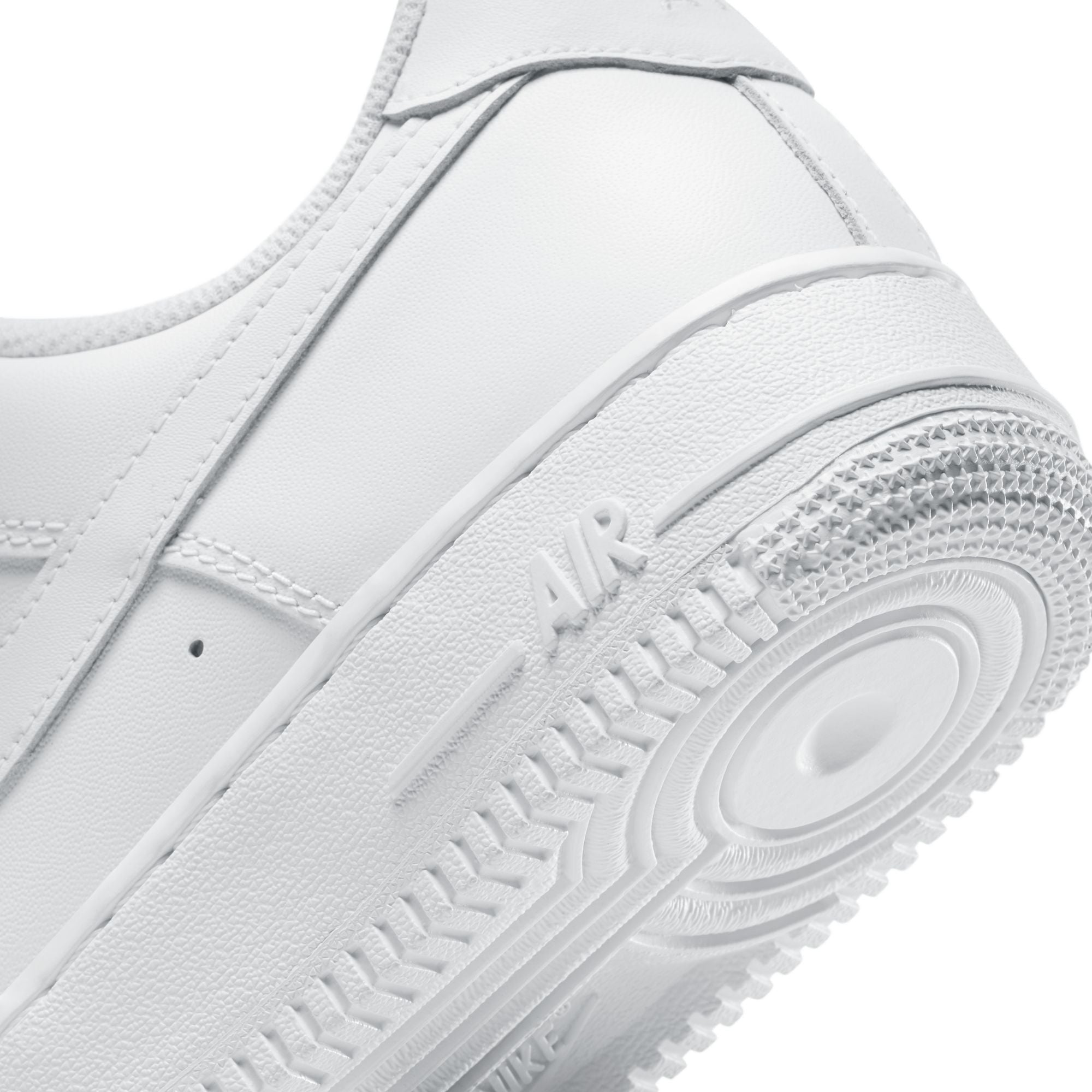 Close-up of a white sneaker with 'Nike' branding on a white background