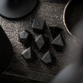 Black obsidian dice with raised numbers