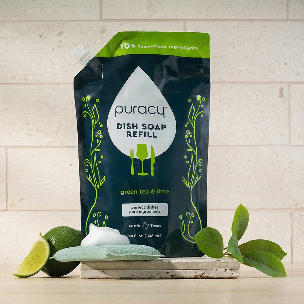 Puracy dish soap refill packaging with green tea and lime scent on a neutral background