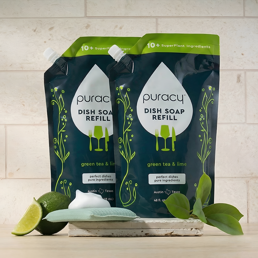 Two puracy dish soap refills with green tea and lime scent on a kitchen counter.
