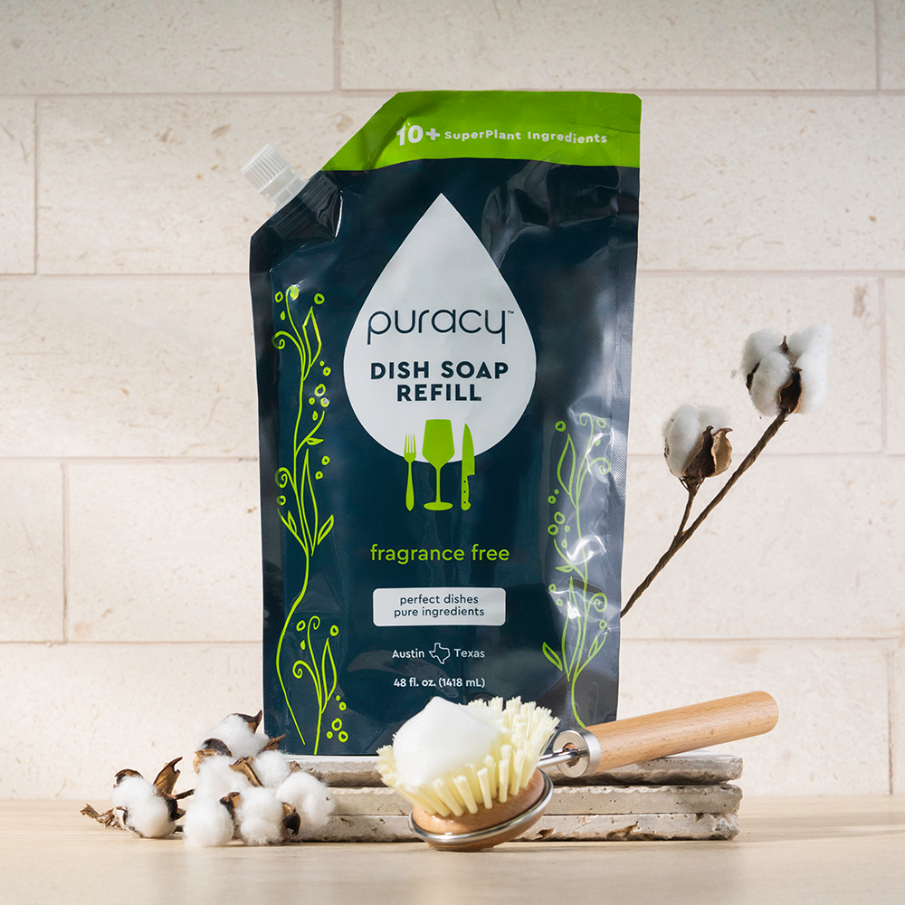 Puracy dish soap refill package with a brush and cotton on a light background