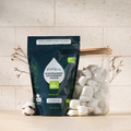 Puracy dishwasher detergent packs on a kitchen counter with a light background