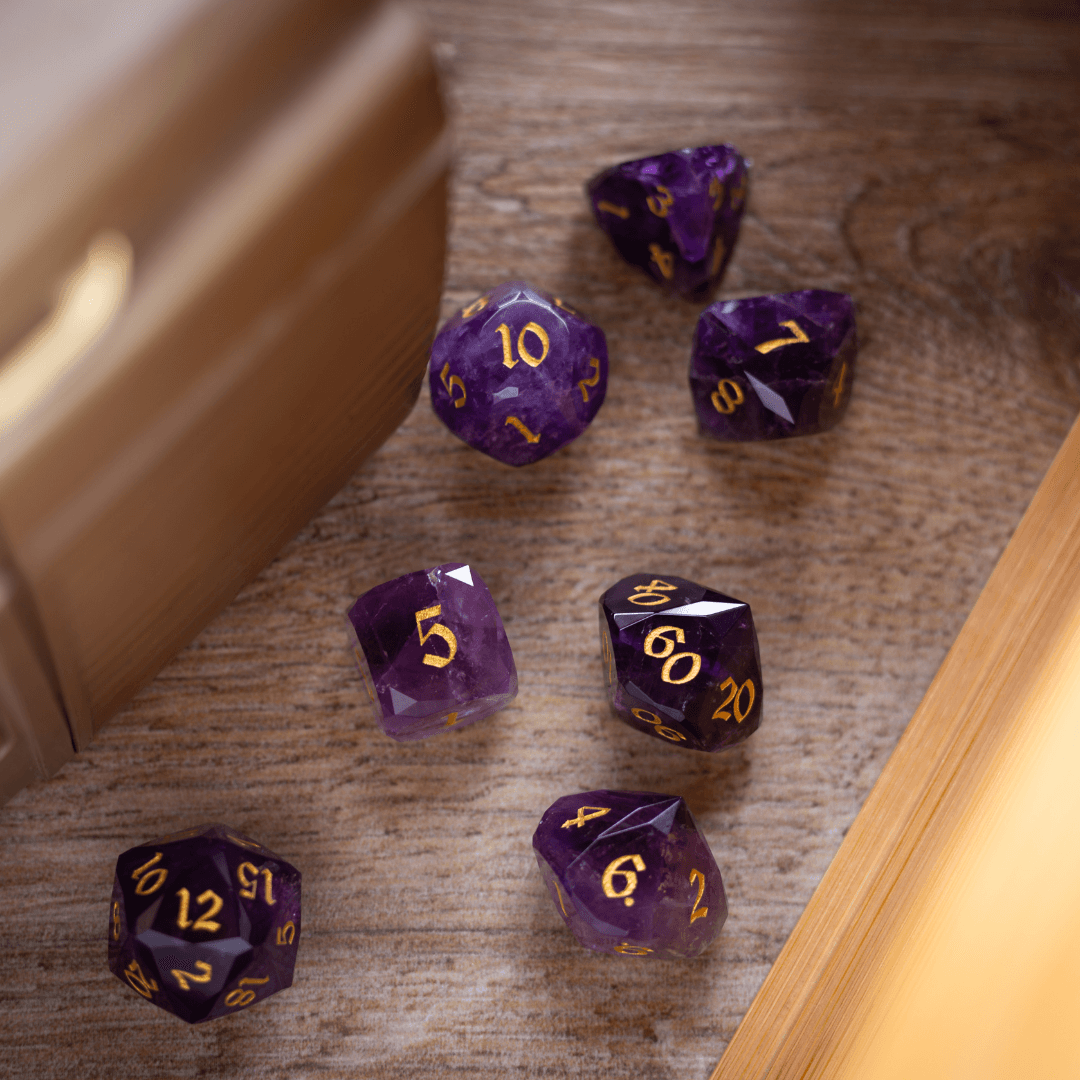 Purple polyhedral dice with gold numbers on a wooden surface