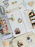 Stationery items including a notebook, stickers, and a pouch with book-themed designs.
