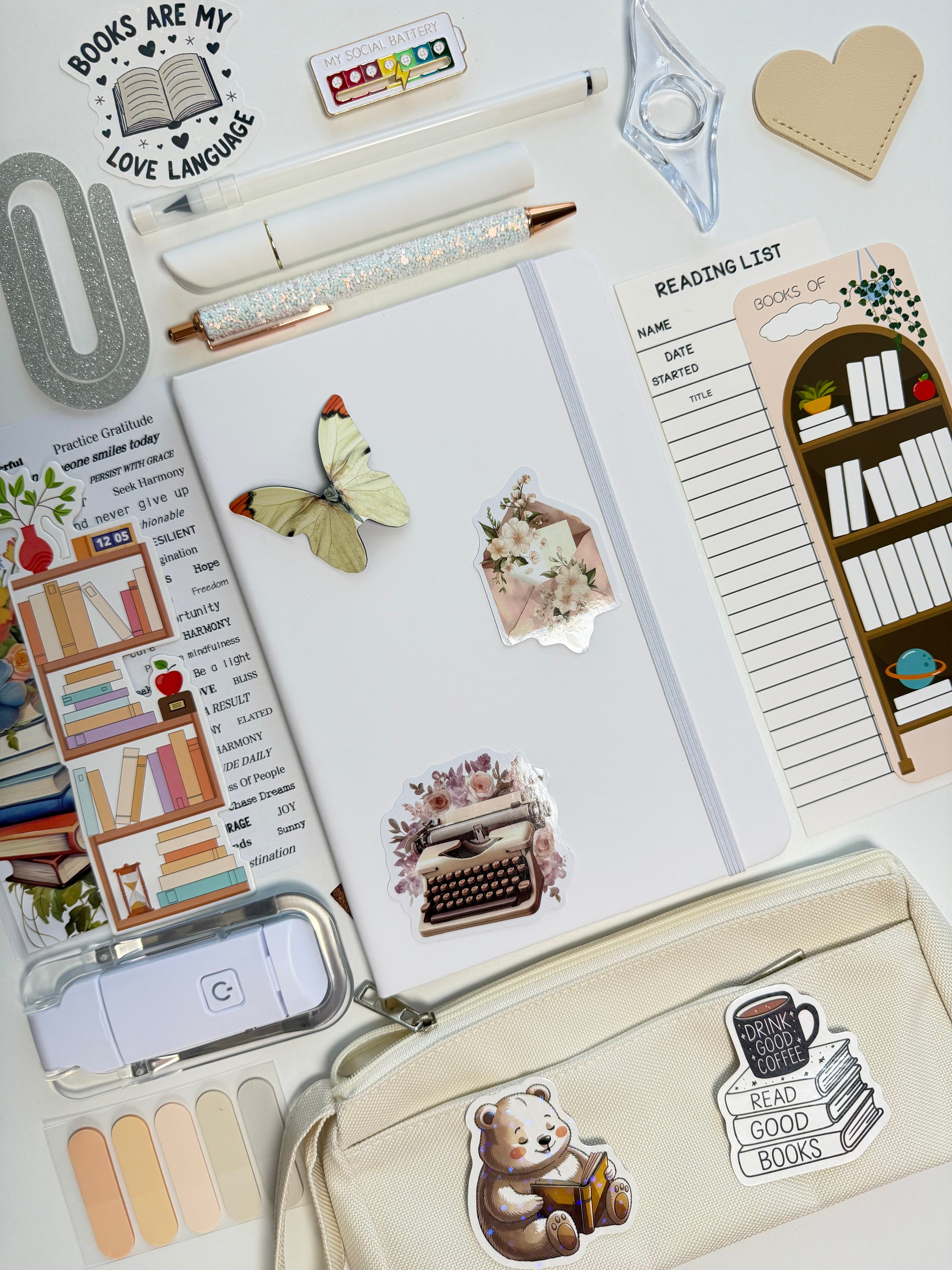 Stationery items including a notebook, stickers, and a pouch with book-themed designs.
