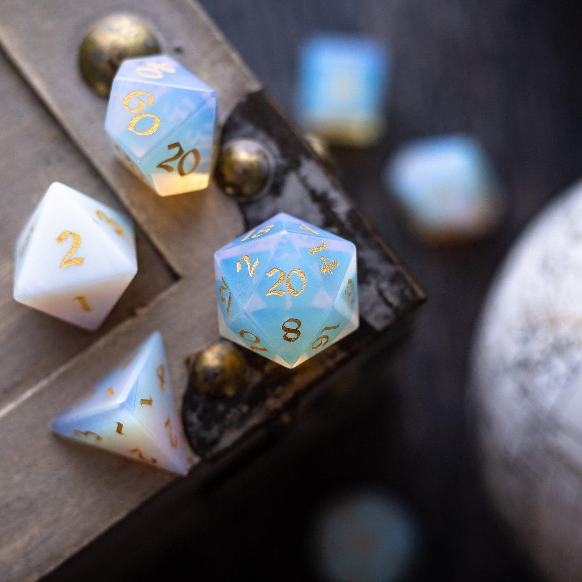 Set of polyhedral dice with gold numbers on a dark surface