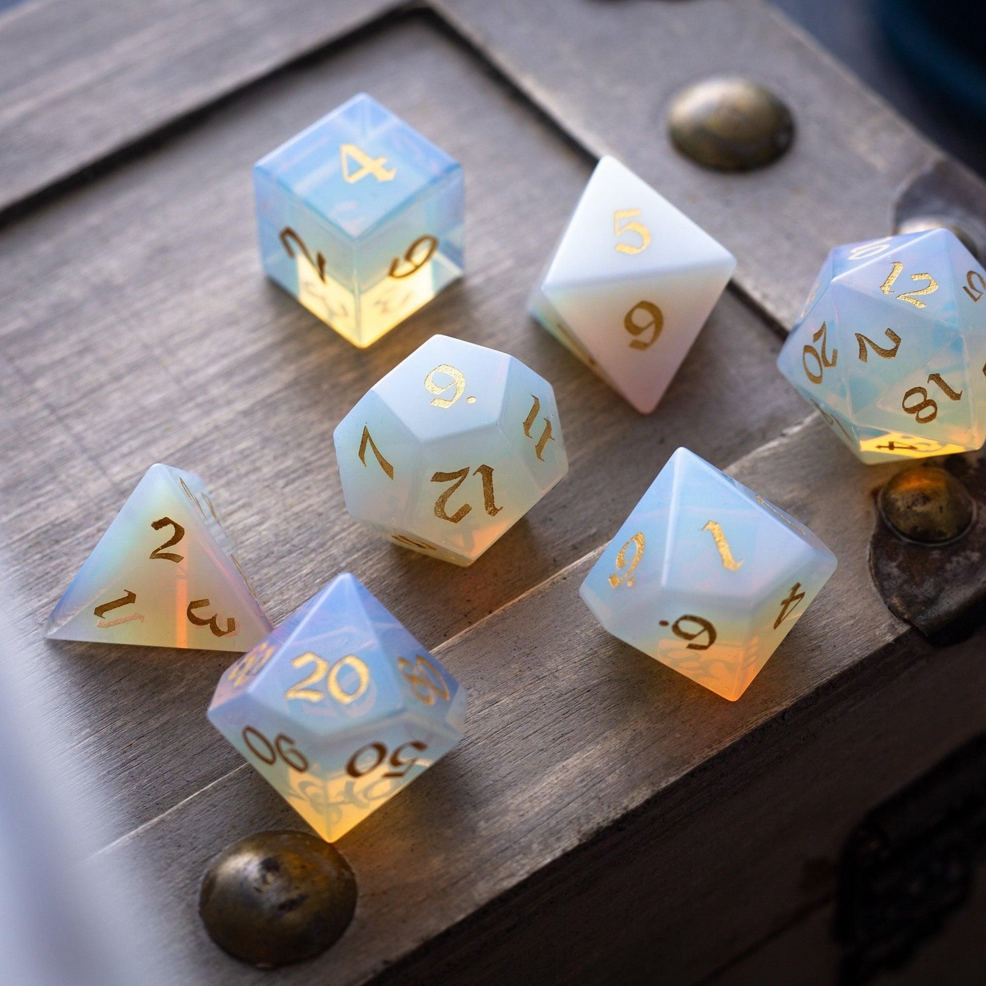 Set of glowing polyhedral dice on a wooden surface