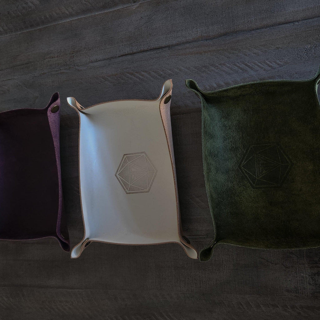 Purple and tan and green leather dice roll tray side by side