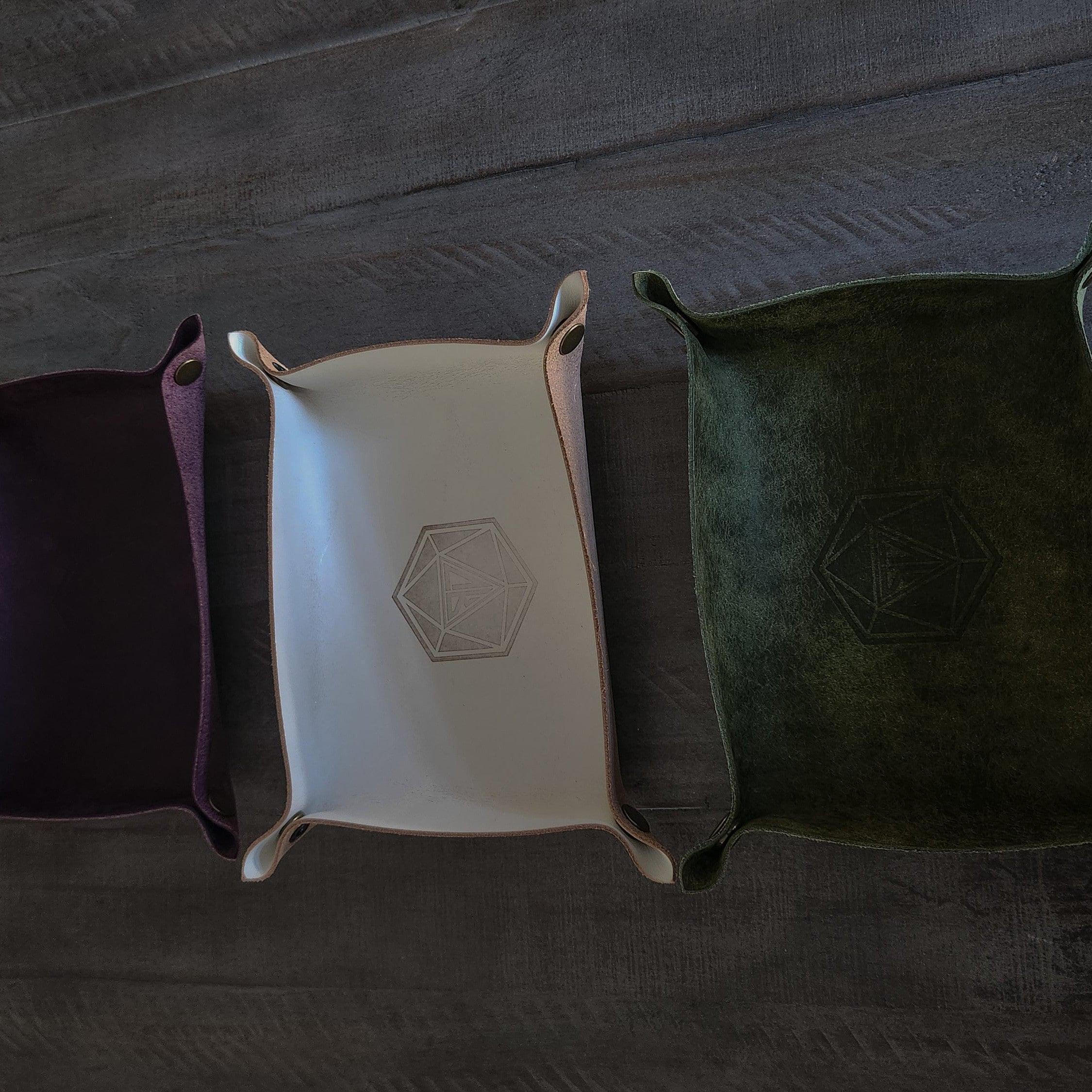 Purple and tan and green leather dice roll tray side by side