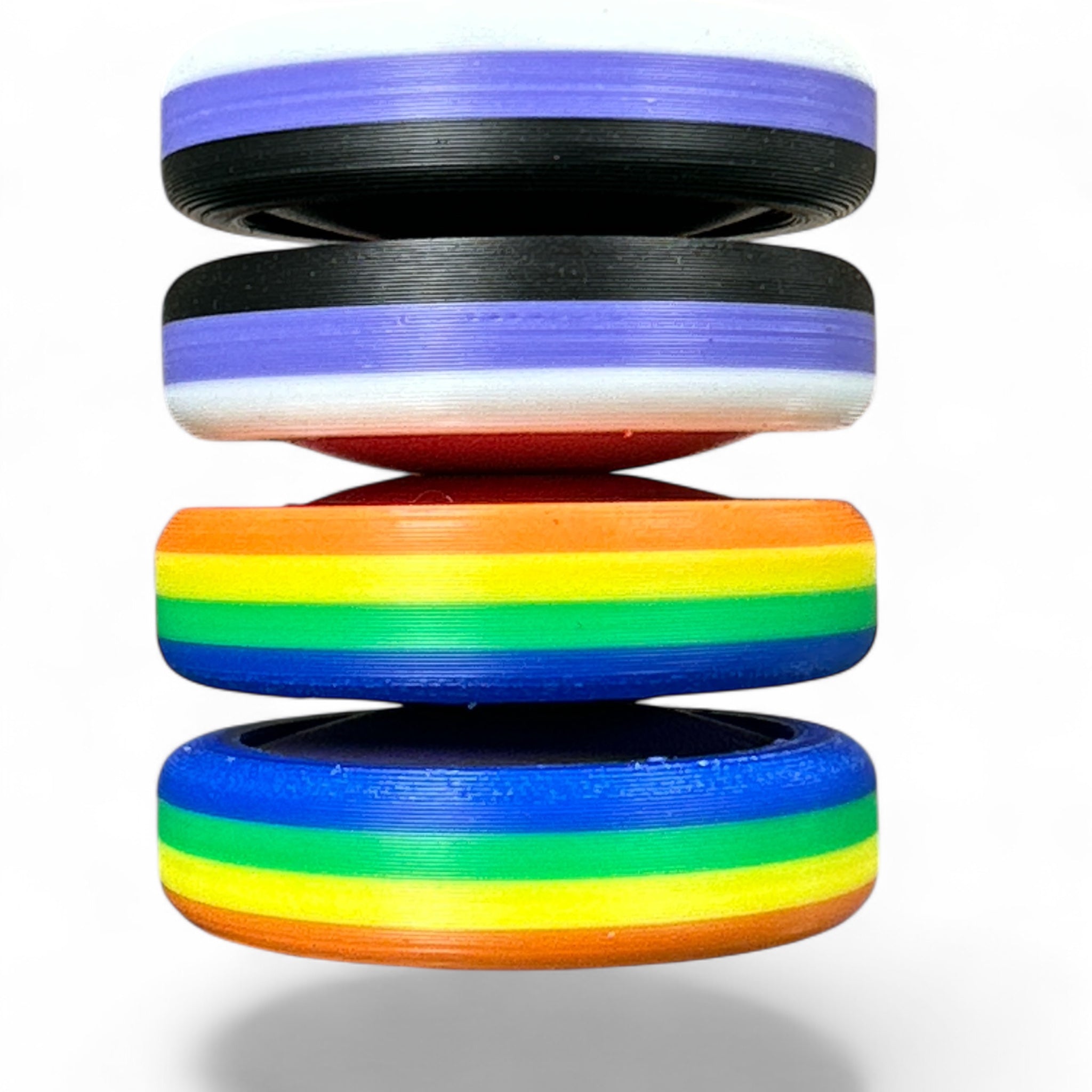 Stack of colorful wheel-like objects with gradient colors on a white background