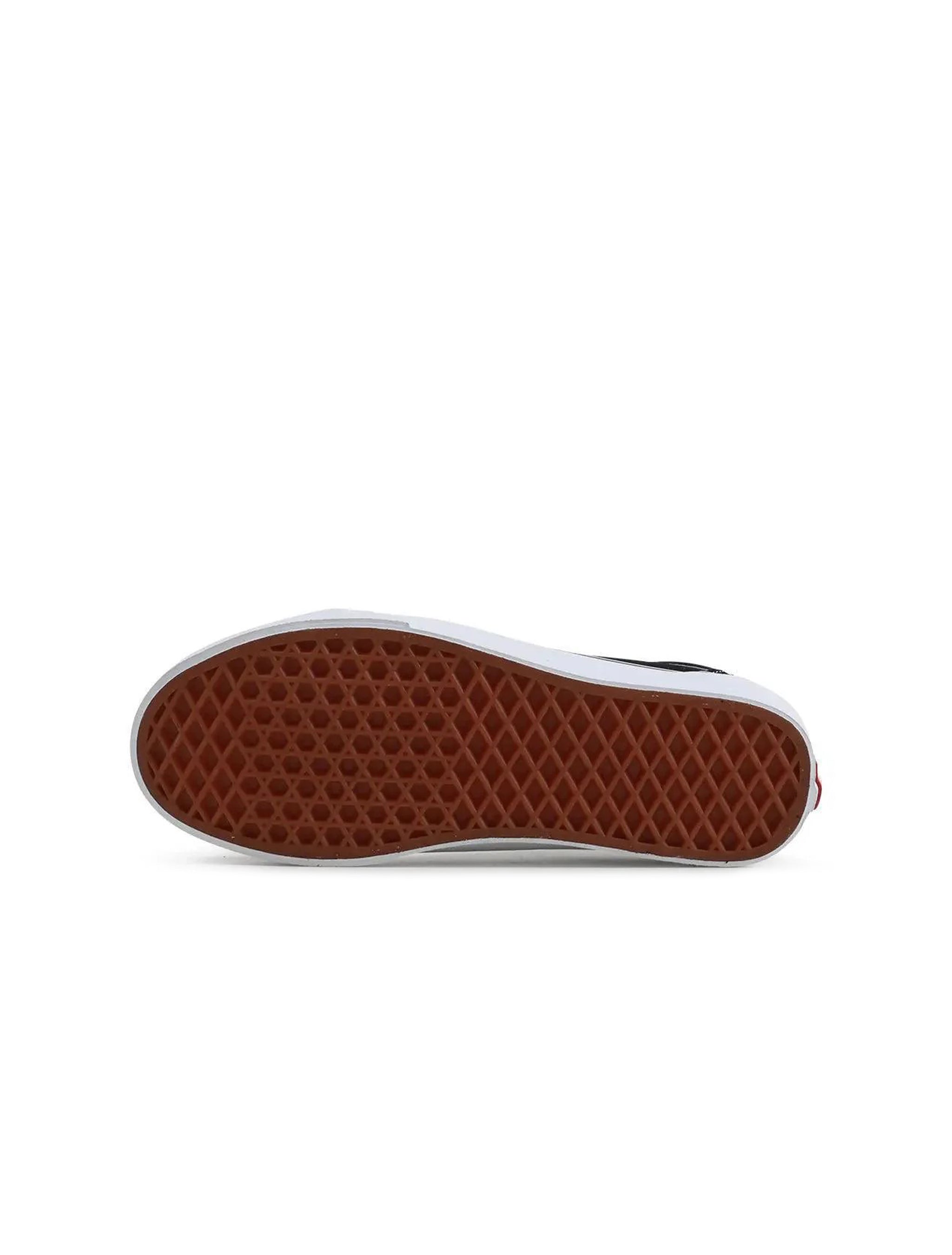 Sole of a shoe with brown rubber sole and white inner lining on a white background