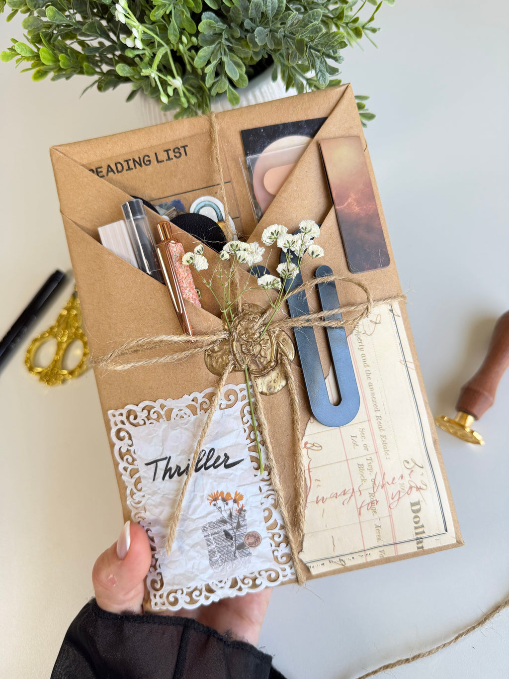 Handmade gift wrapped in brown paper with decorative elements on a light background