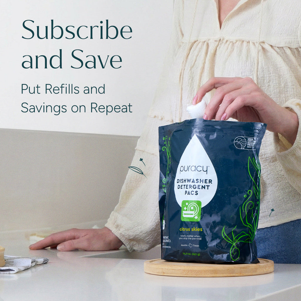 Person holding a puracy dishwasher detergent pac on a kitchen counter with text about subscribing and saving.