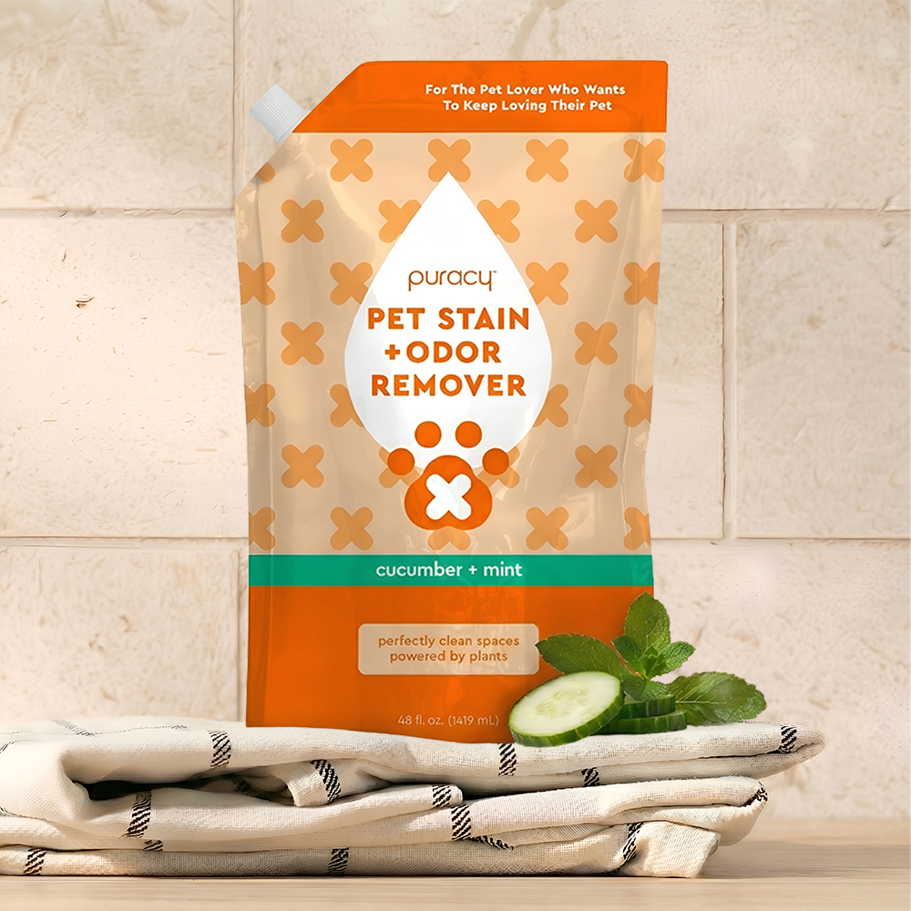 Puracy Pet Stain + Odor Remover refill package with cucumber and mint flavor on a towel background.