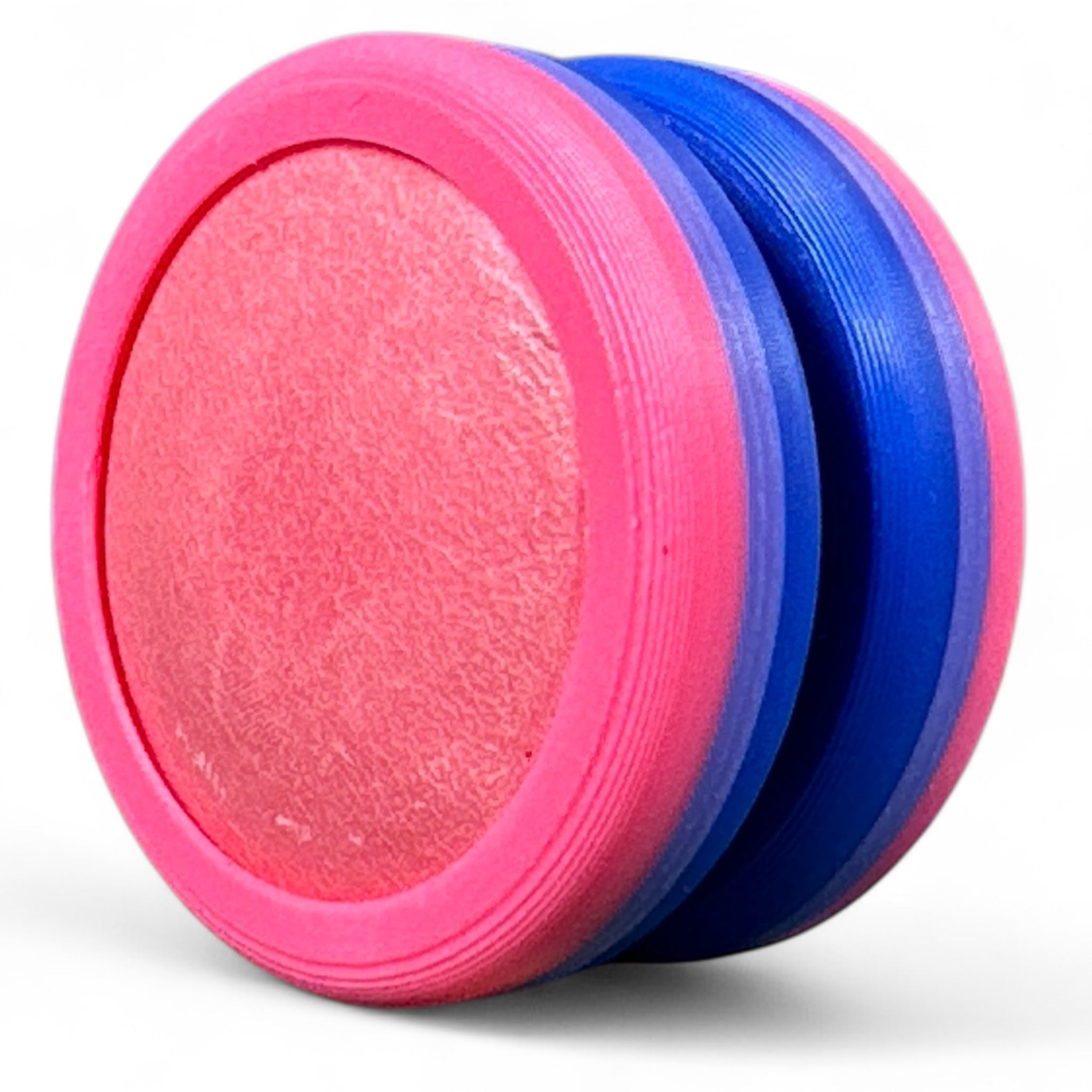 Two colorful plastic discs, one pink and one blue, on a white background