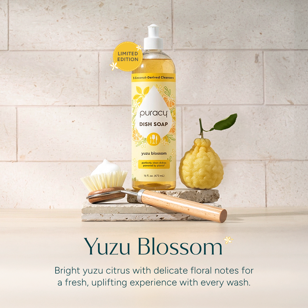 Bottle of puracy dish soap with yuzu blossom scent on a stone surface.