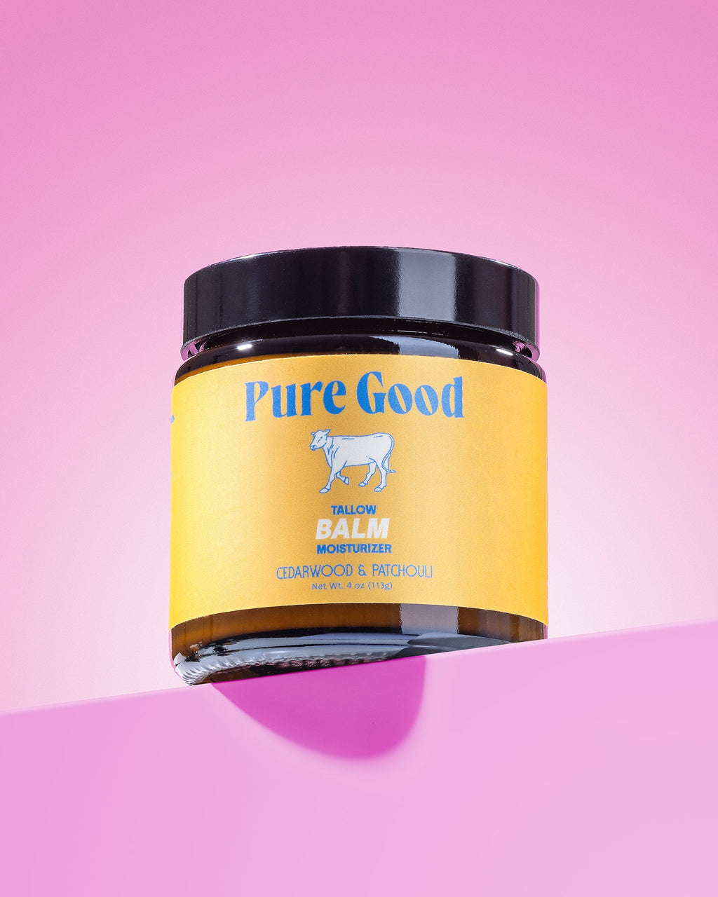 Jar of 'Pure Good' balm on a pink background