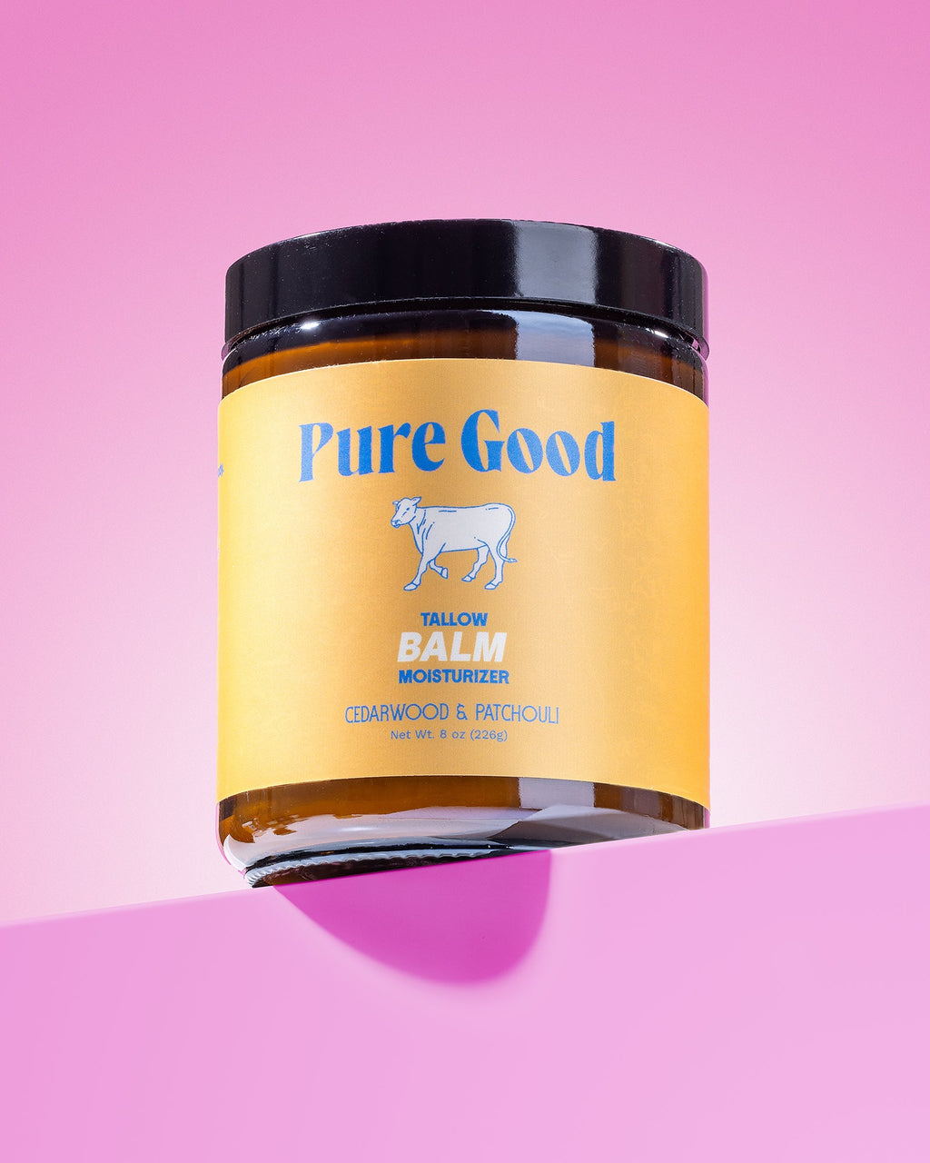 Jar of 'Pure Good' balm on a pink background
