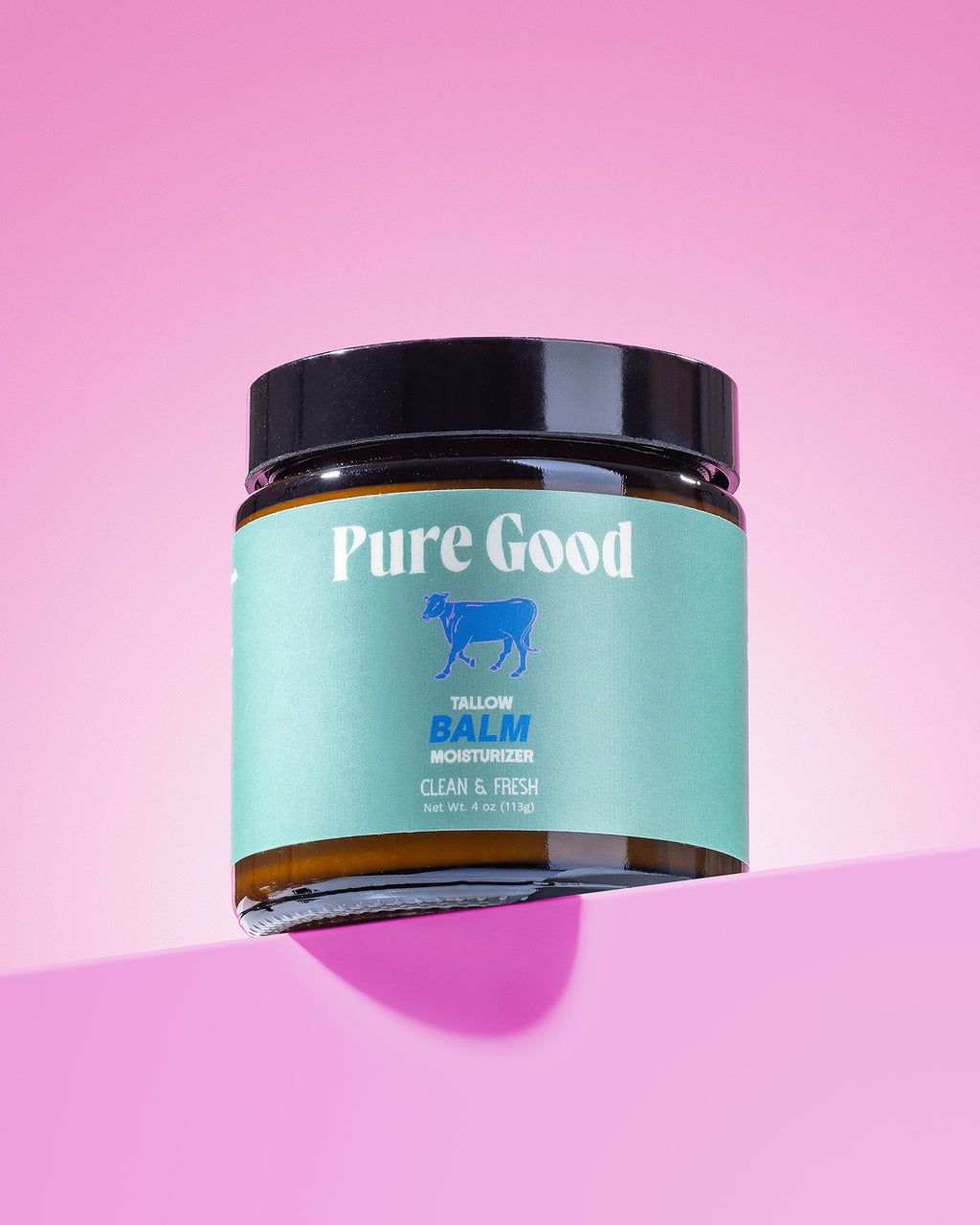 Jar of 'Pure Good' balm on a pink background