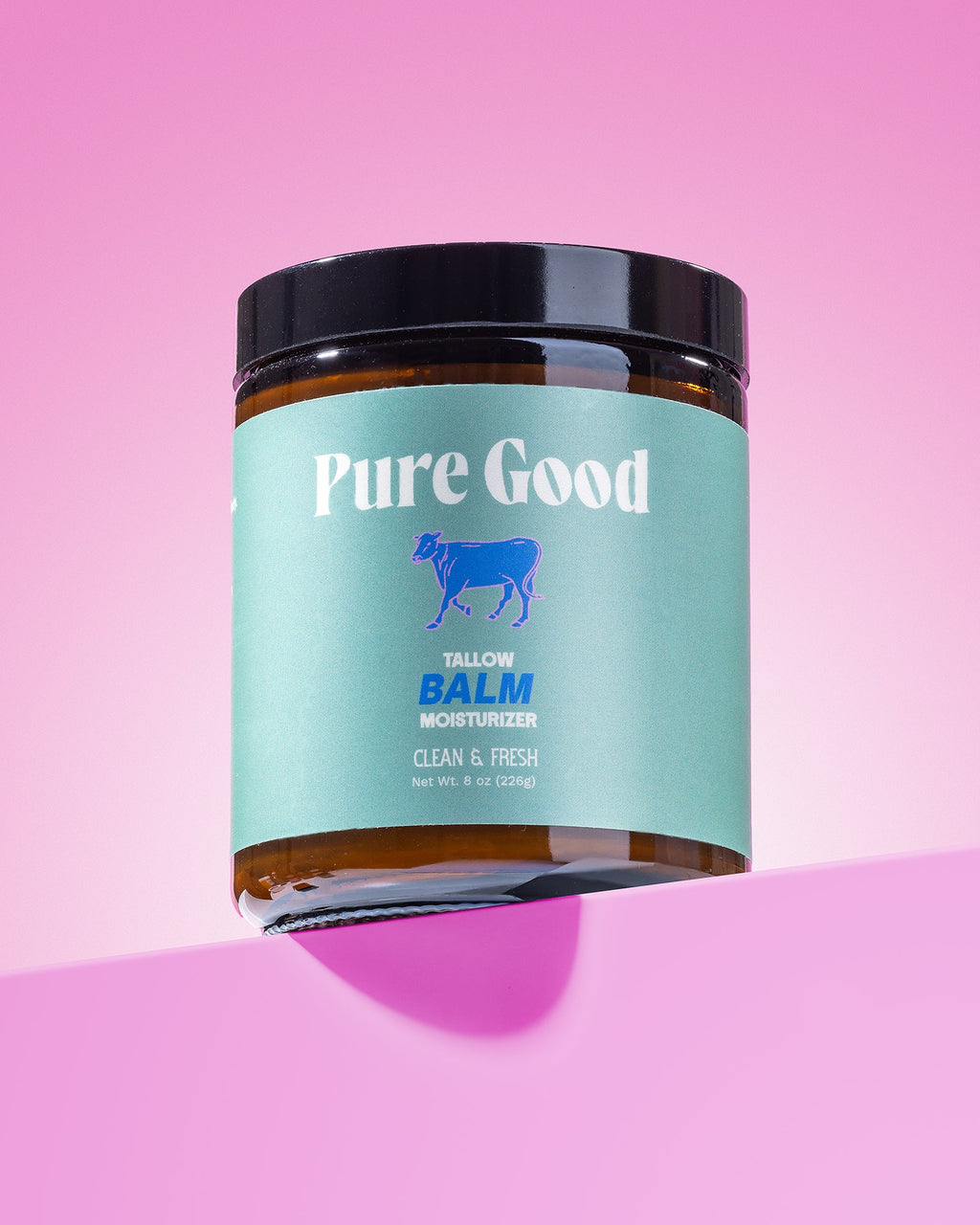 Jar of 'Pure Good' balm on a pink background