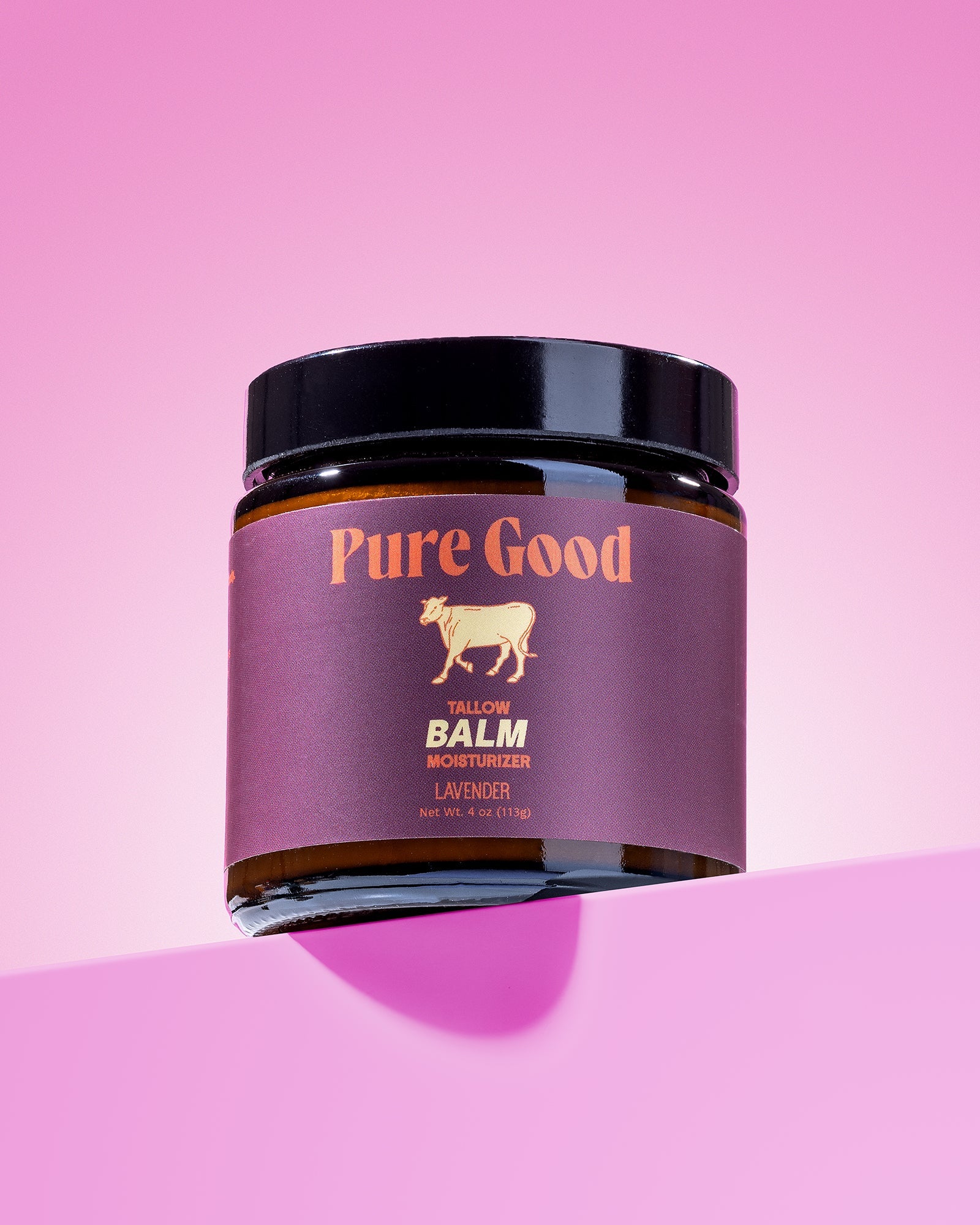 Jar of 'Pure Good' balm on a pink background