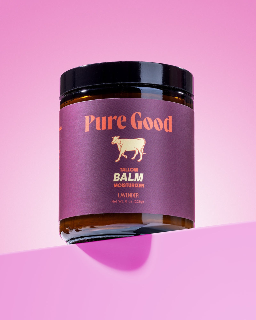 Jar of 'Pure Good' balm on a pink background