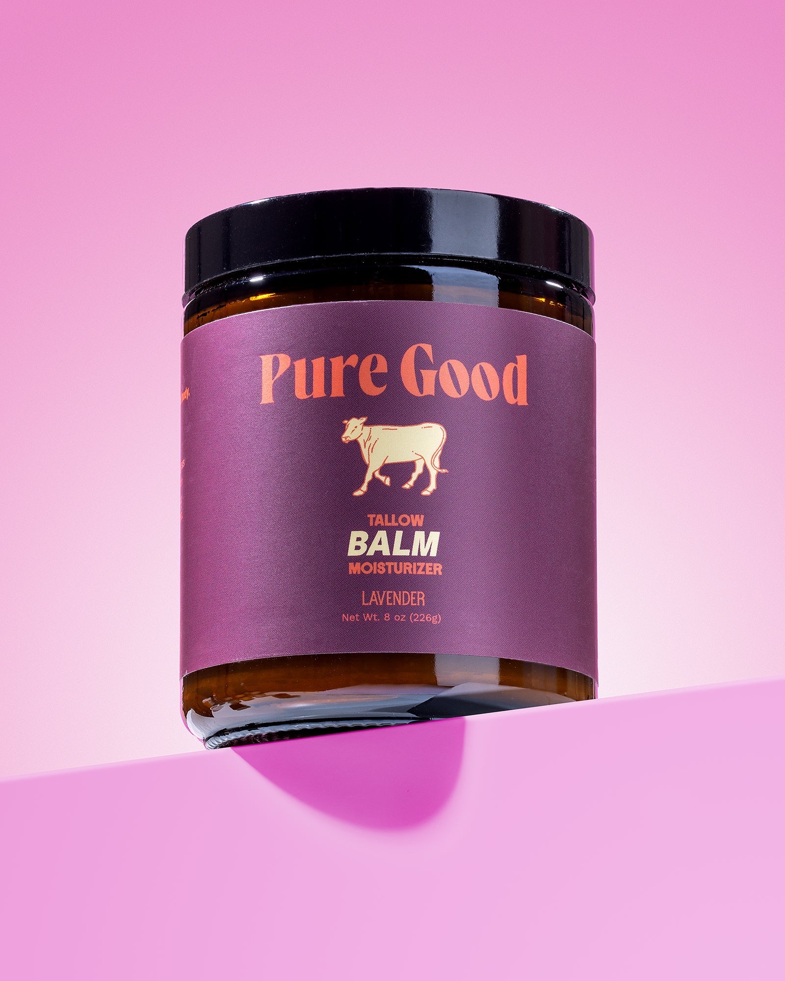 Jar of 'Pure Good' balm on a pink background