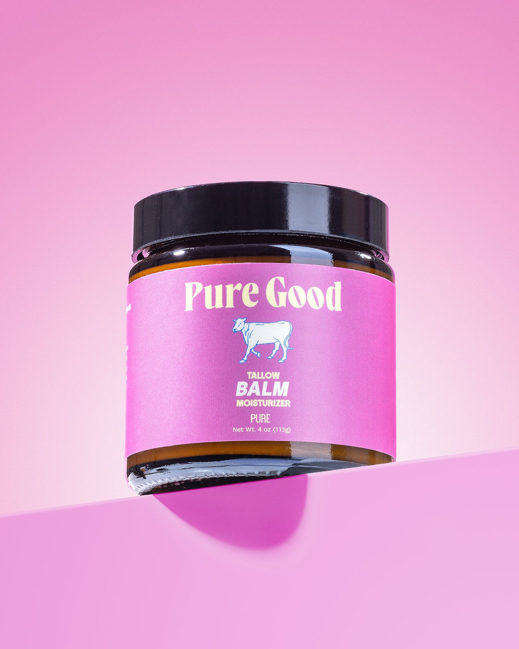 Jar of 'Pure Good' balm on a pink background