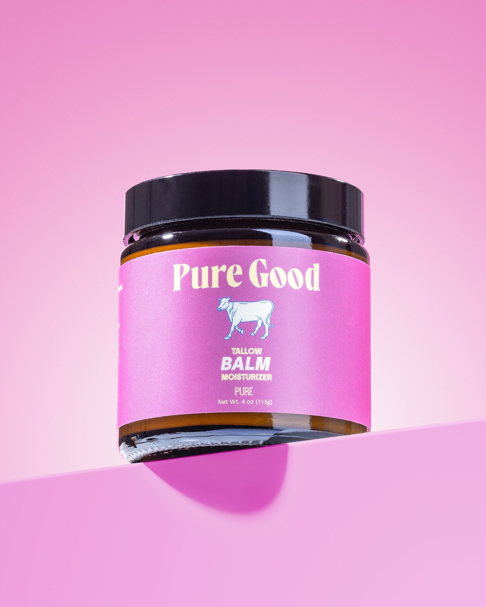 Jar of 'Pure Good' balm on a pink background