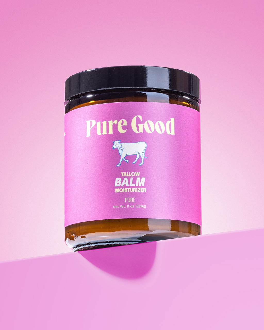 Jar of 'Pure Good' balm on a pink background