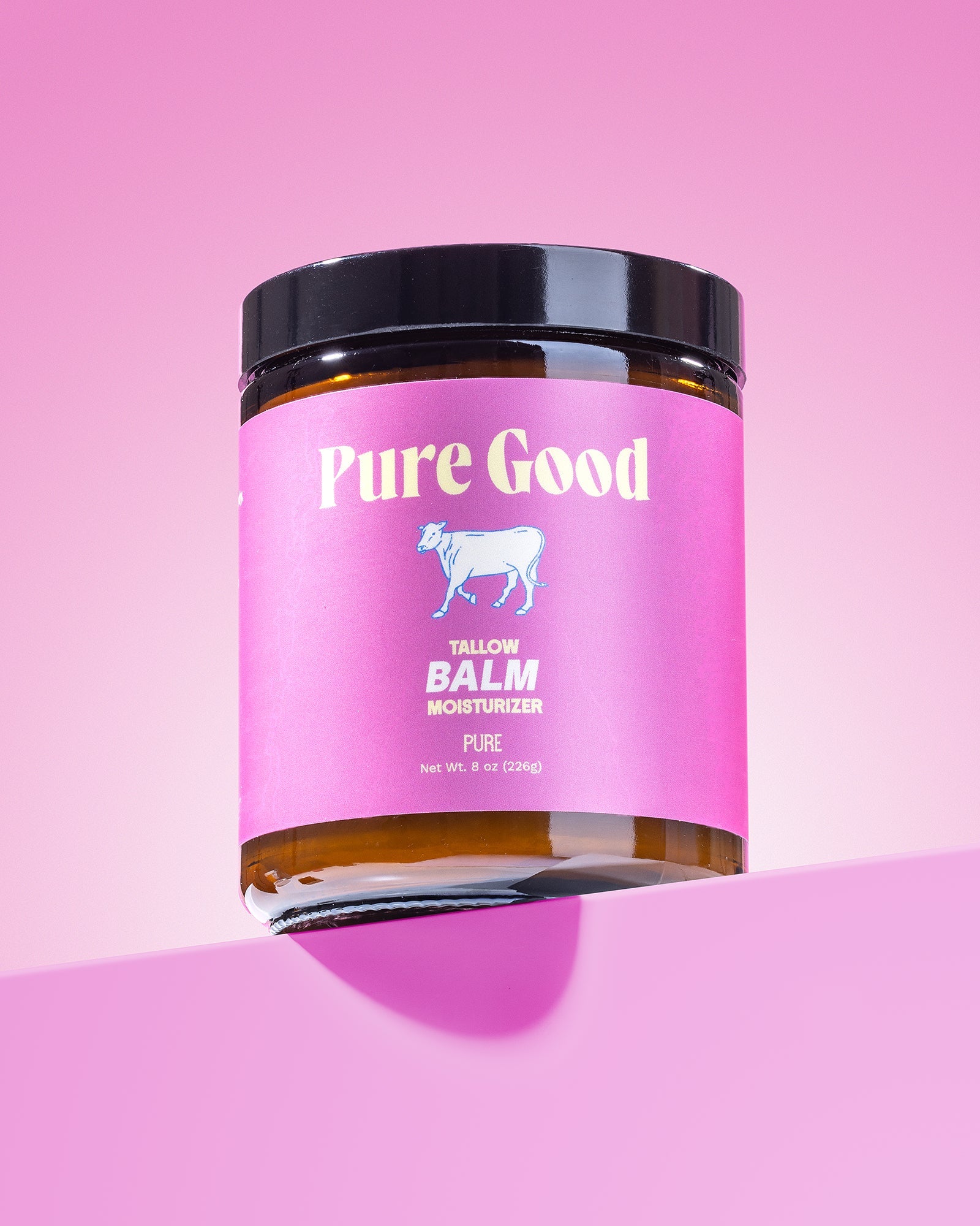 Jar of 'Pure Good' balm on a pink background