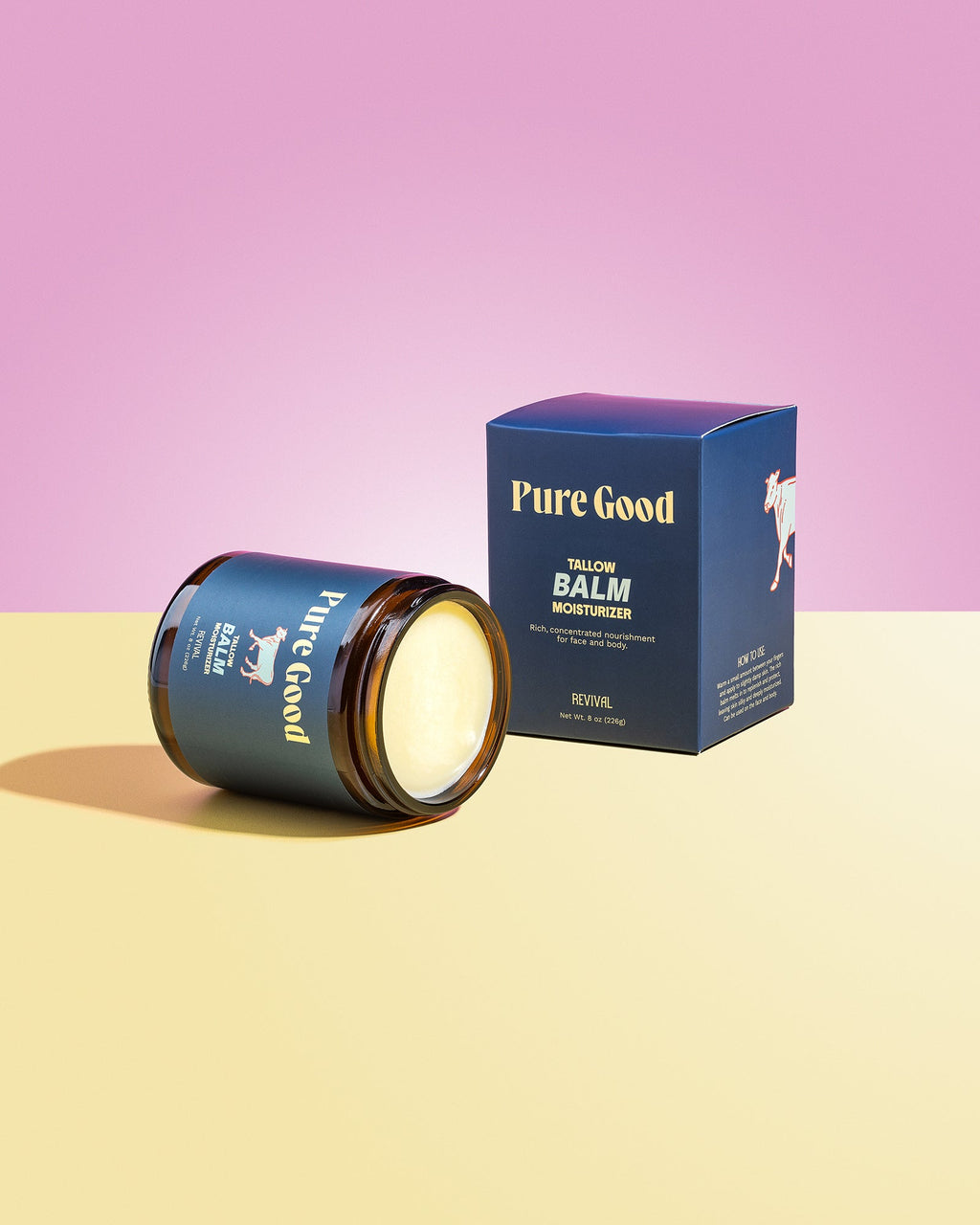 Jar of 'Pure Good' balm with packaging on a pink and yellow gradient background