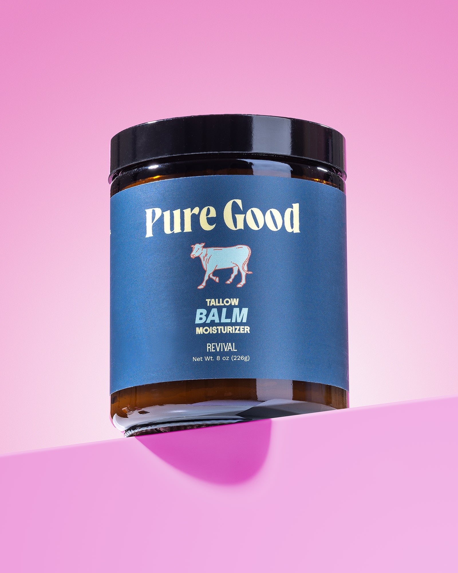 Jar of 'Pure Good' balm on a pink background