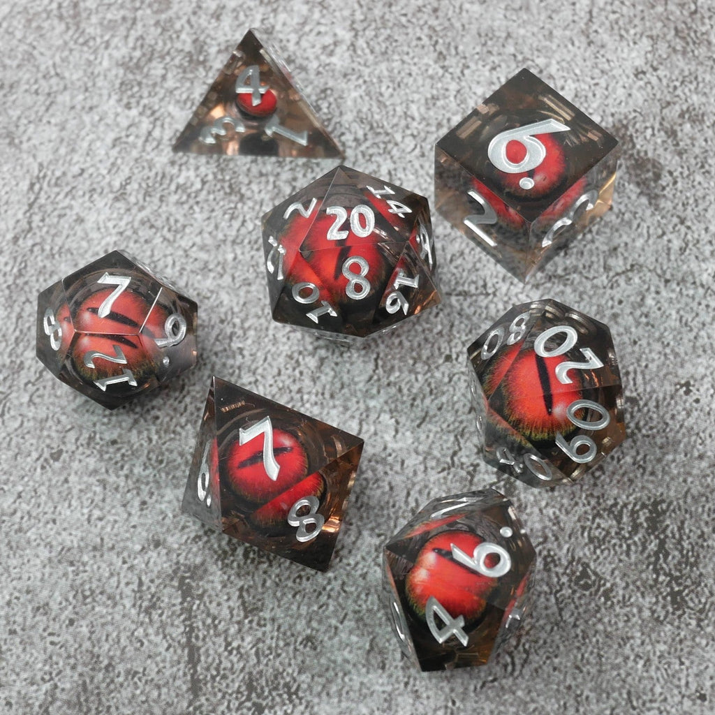 Set of polyhedral dice with red and silver numbers on a gray surface