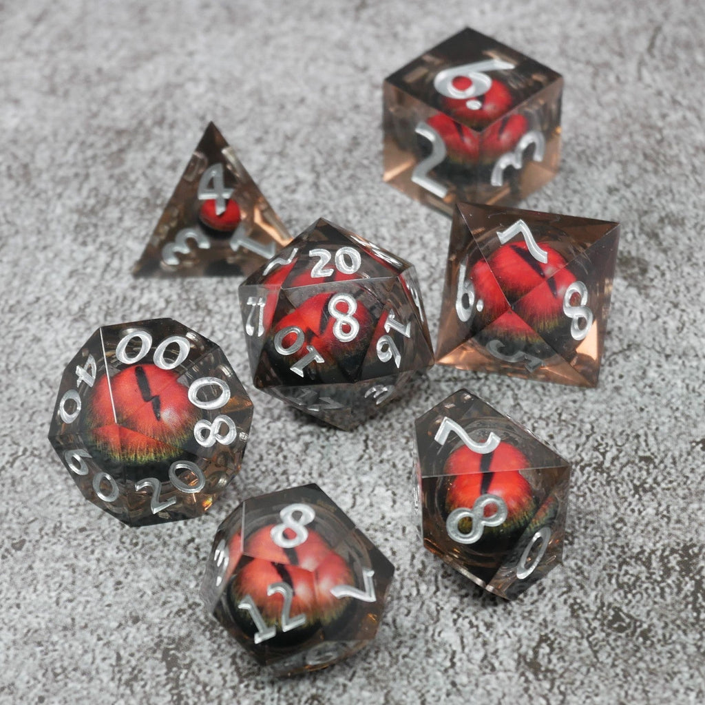 Set of polyhedral dice with red and black design on a gray surface