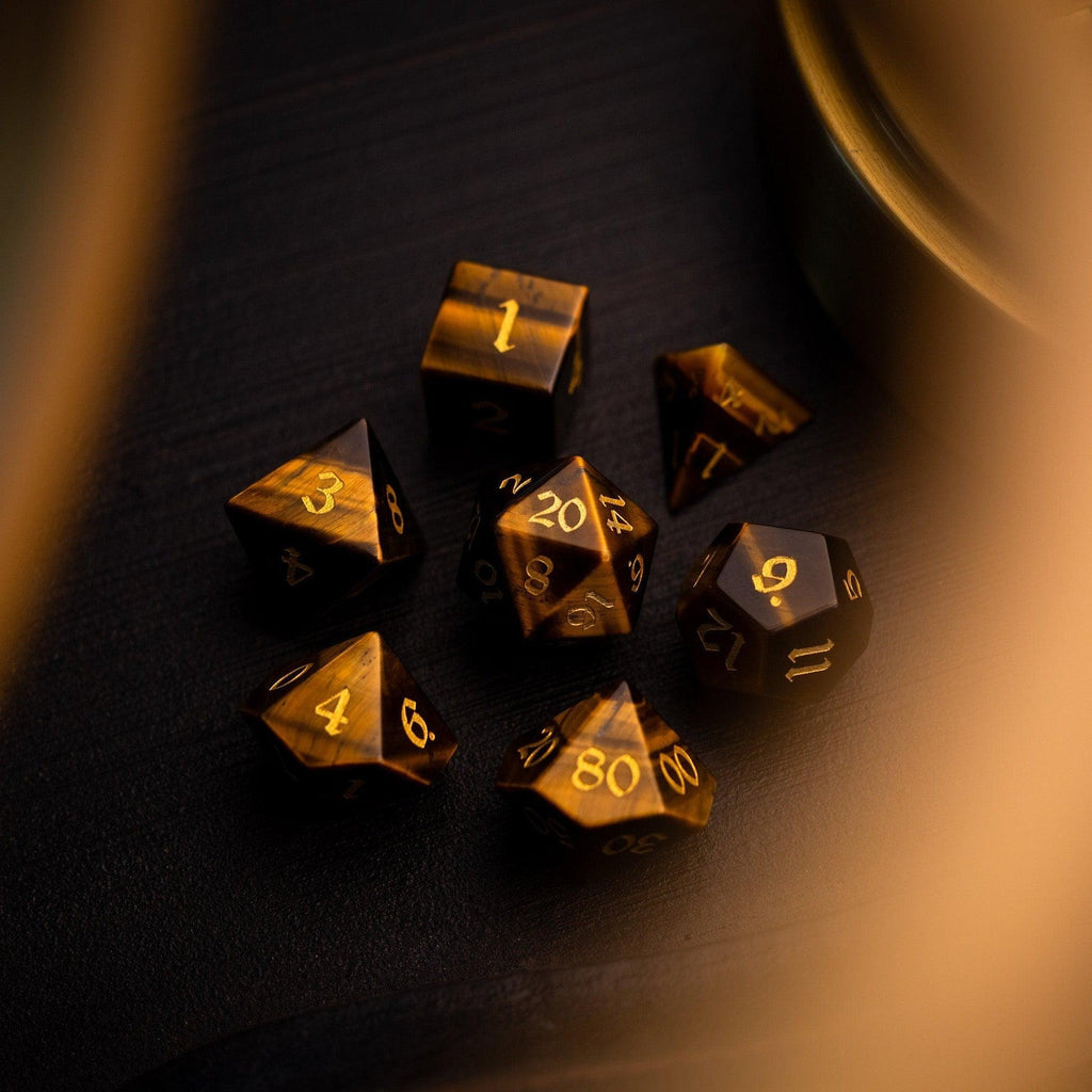 Gold polyhedral dice set on a dark surface