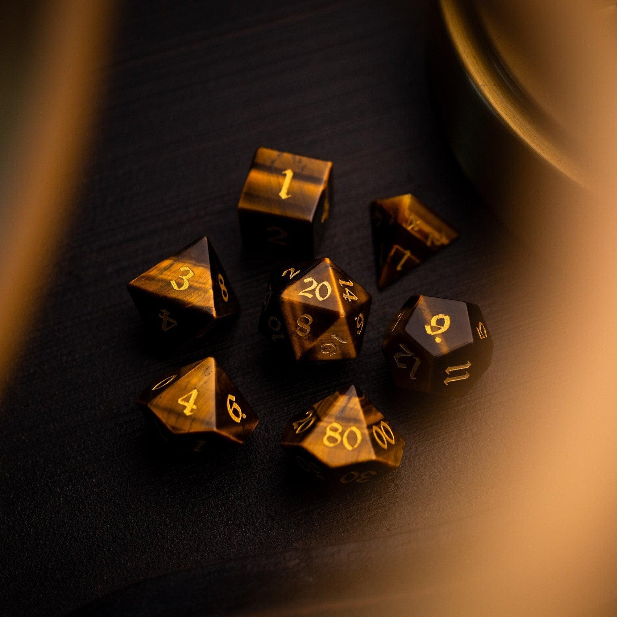 Gold polyhedral dice set on a dark surface
