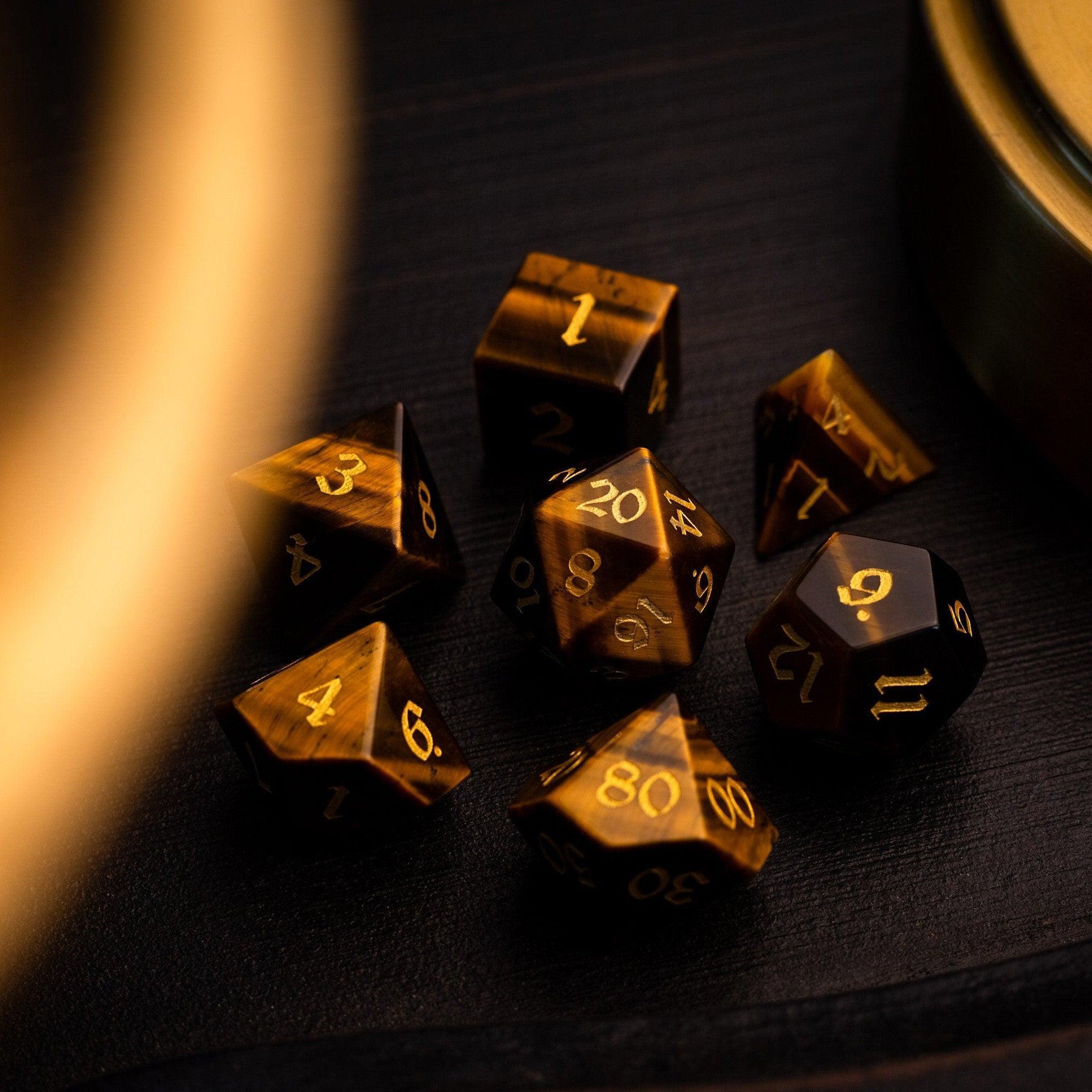 Gold polyhedral dice set on a dark surface