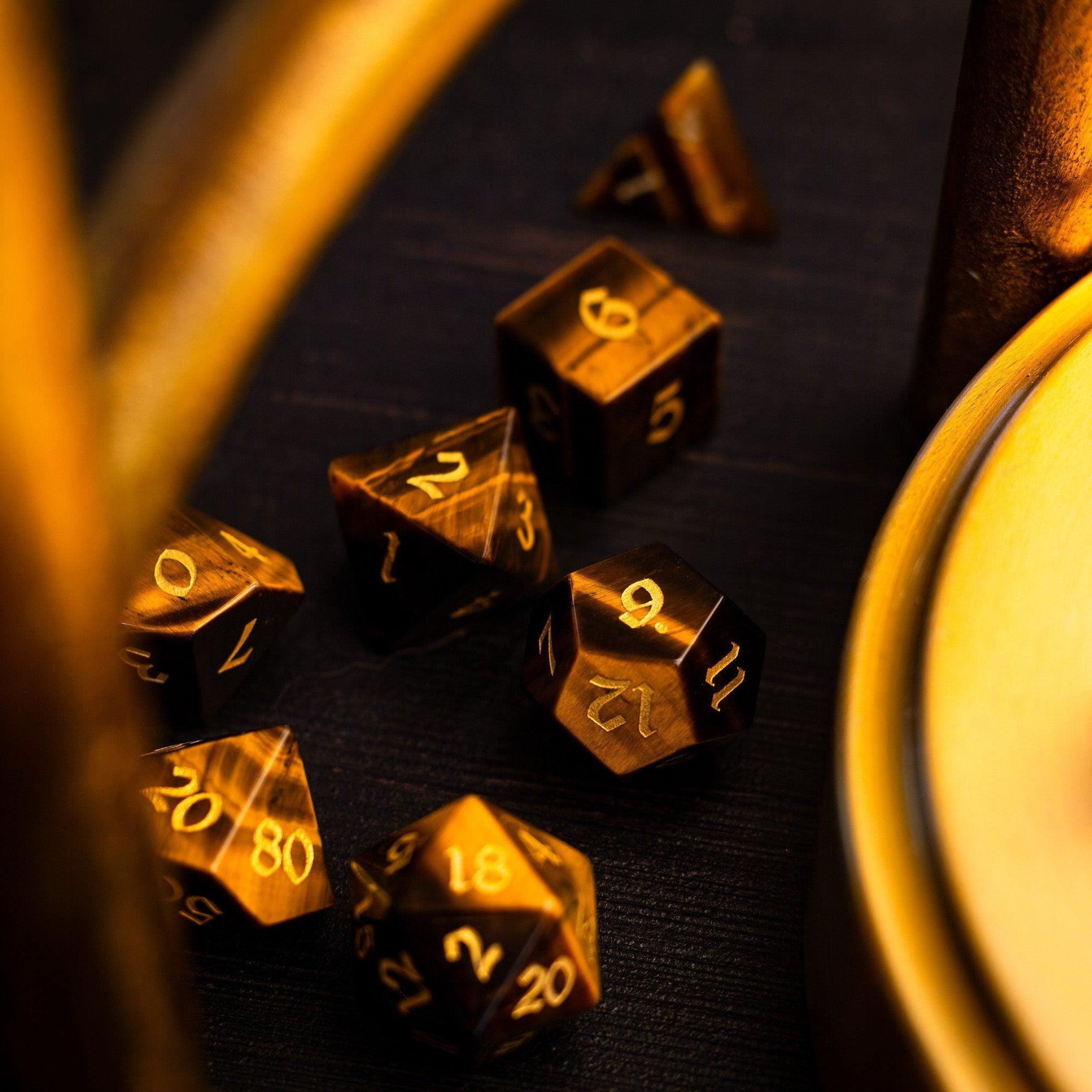 Gold polyhedral dice set on a dark surface