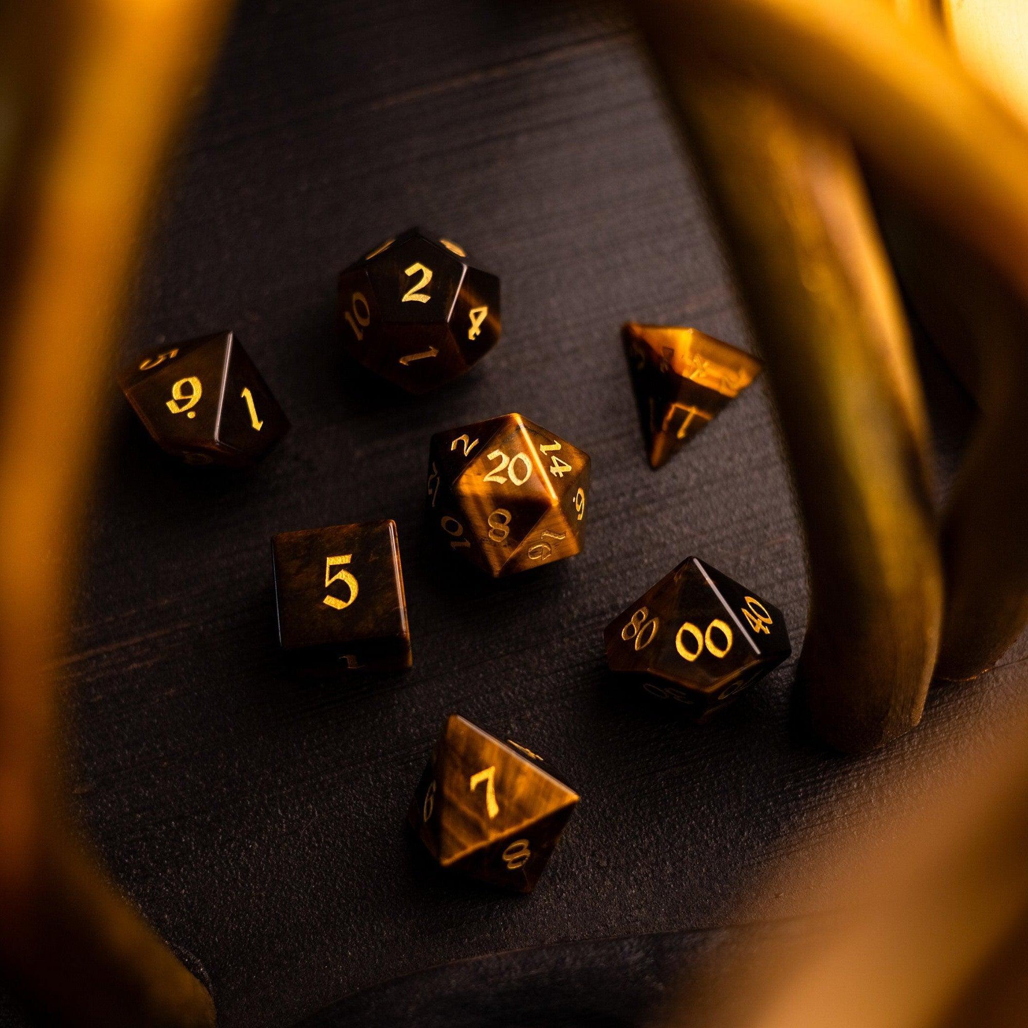 Gold polyhedral dice on a dark surface