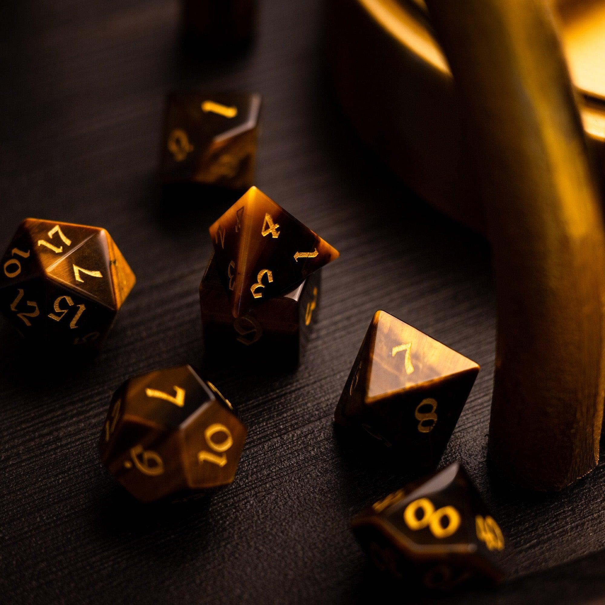 Gold polyhedral dice on a dark surface