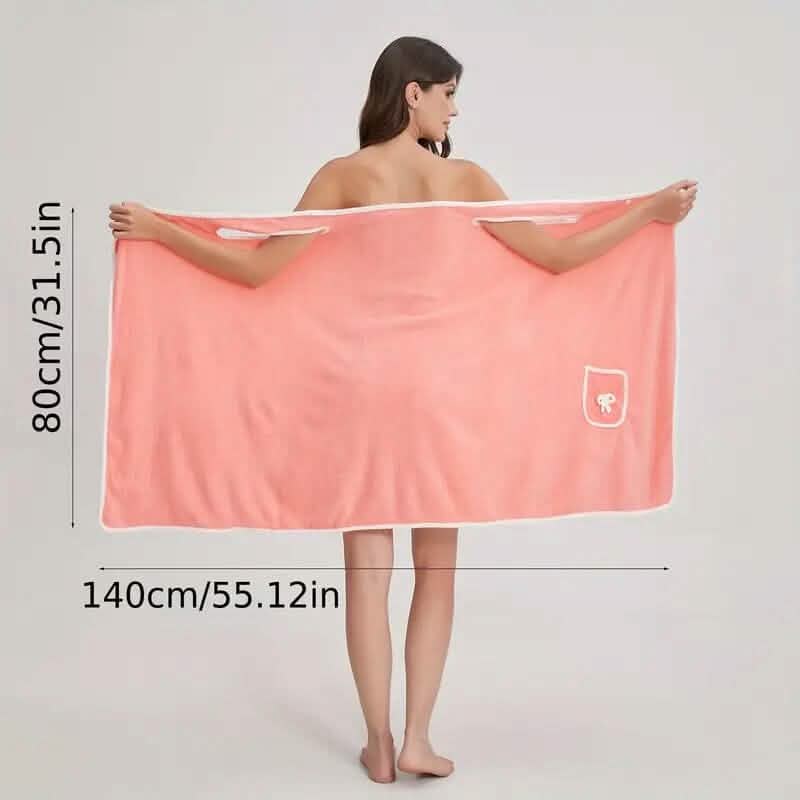 Woman holding a peach-colored towel with dimensions displayed on a white background