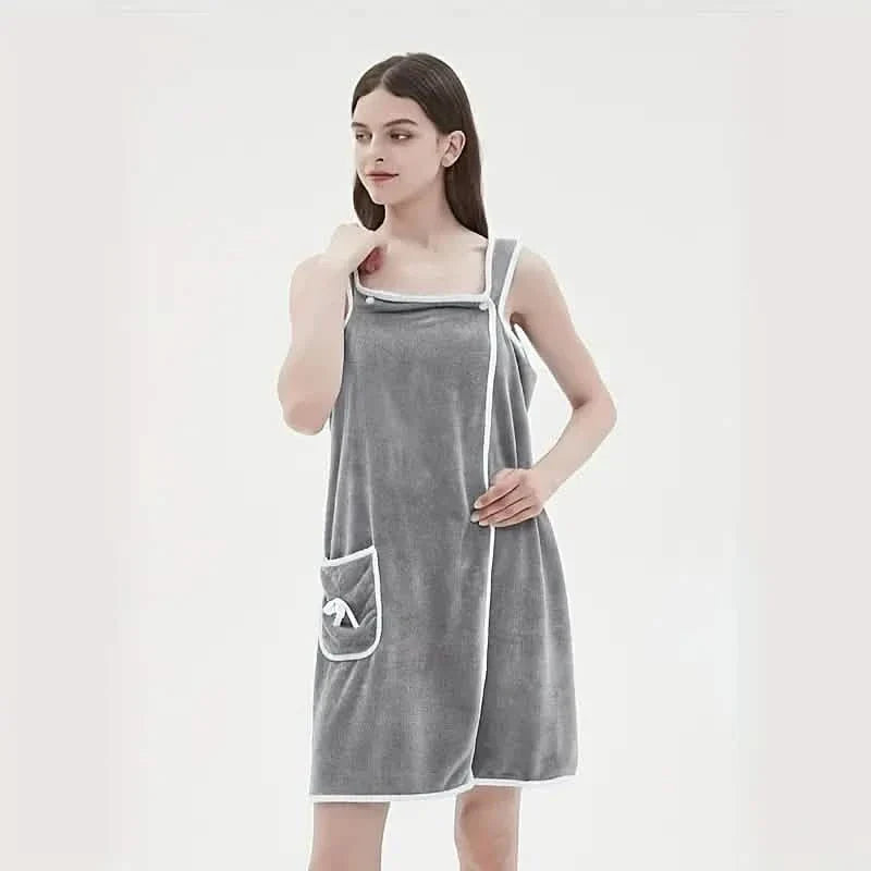 Woman wearing a gray apron with a pocket on a white background