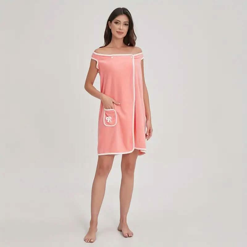 Woman wearing a pink off-shoulder dress with a white pocket on a light gray background